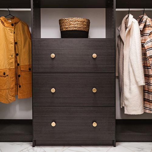 Dark drawers inside coat closet for accessory storage