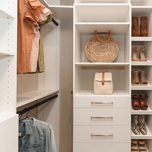 Alternative view of white master closet with shoe and purse shelving